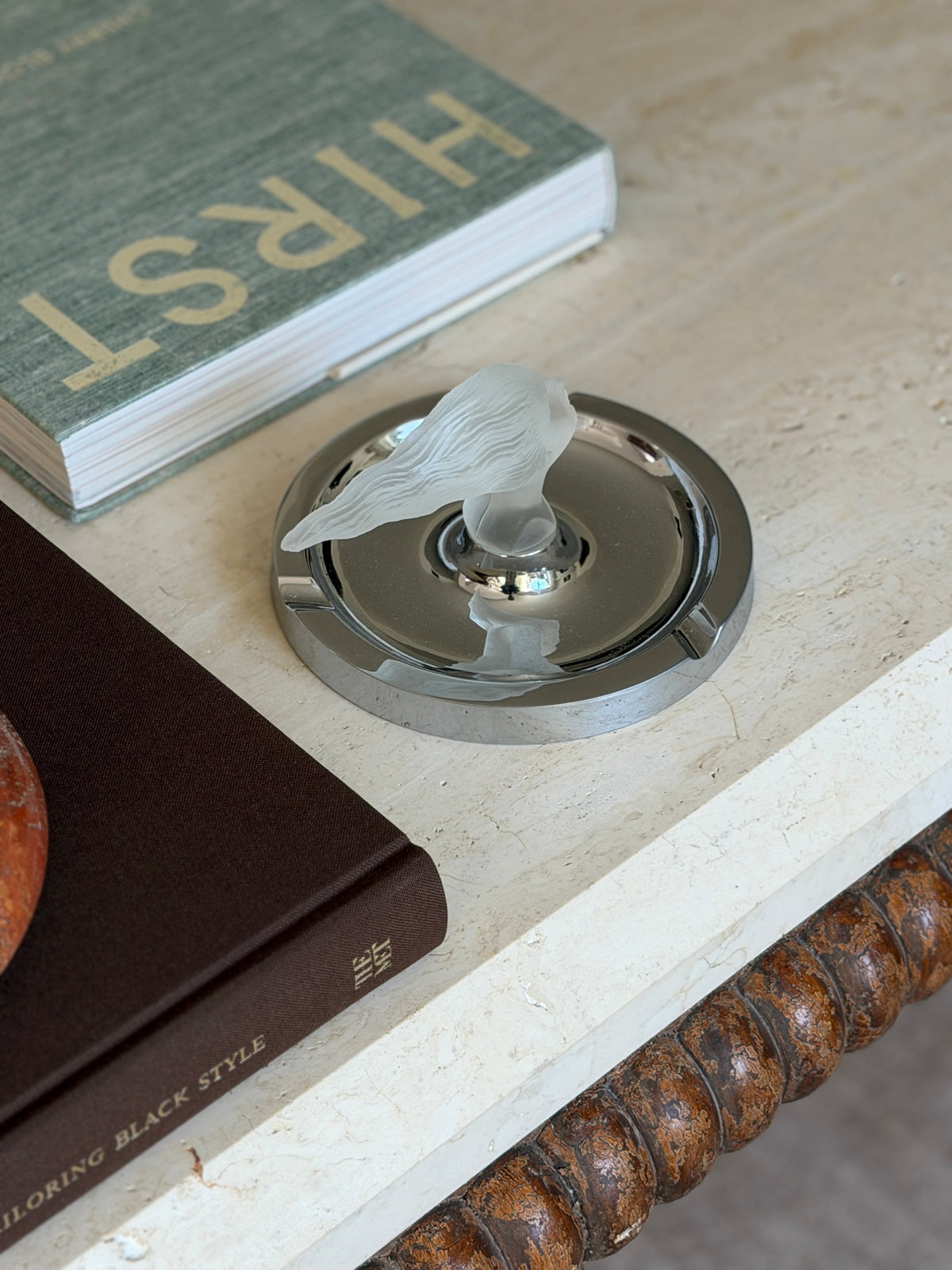 Angled view of the ashtray displayed on a stack of books