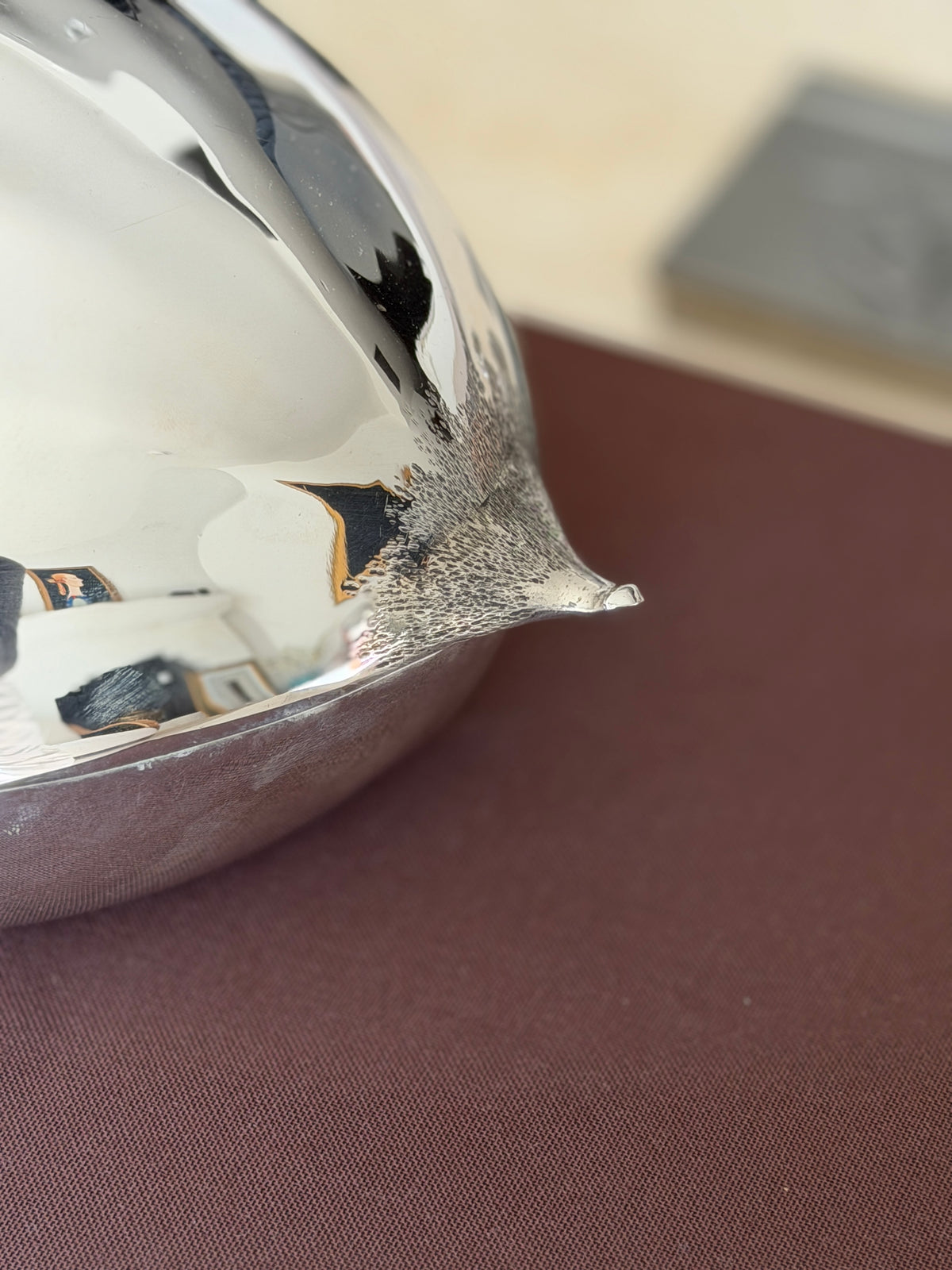 Close up of the chestnut box tip, the finely textured silver shell rising to a small pointed stem above the polished base