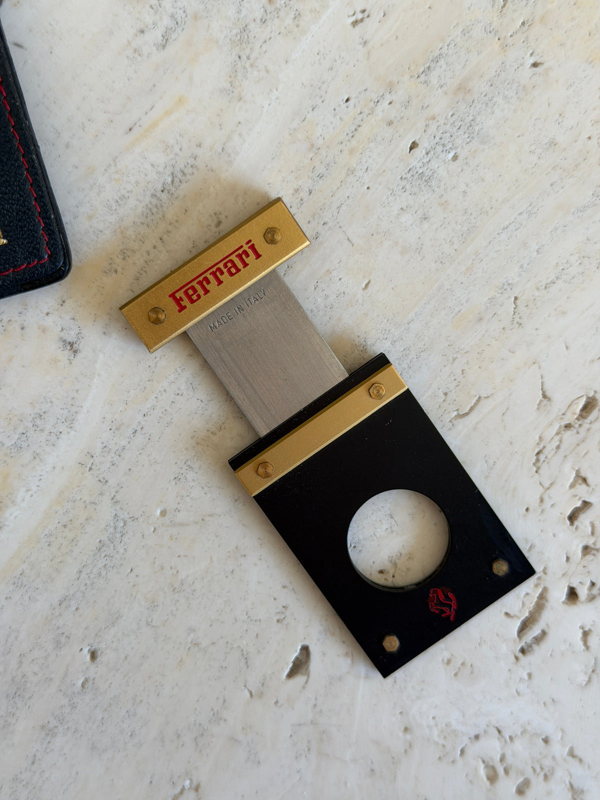 Close-up of the Ferrari and Made in Italy engraving on the extended cutter blade