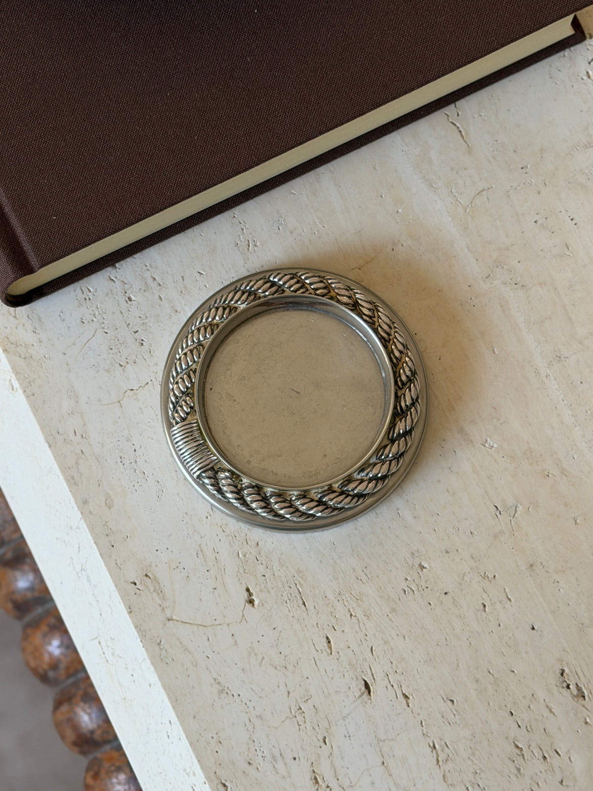 Overhead view of the Hermes Cordage drink coaster showing the full circle of twisted rope relief and the wrapped binding detail around a smooth center well