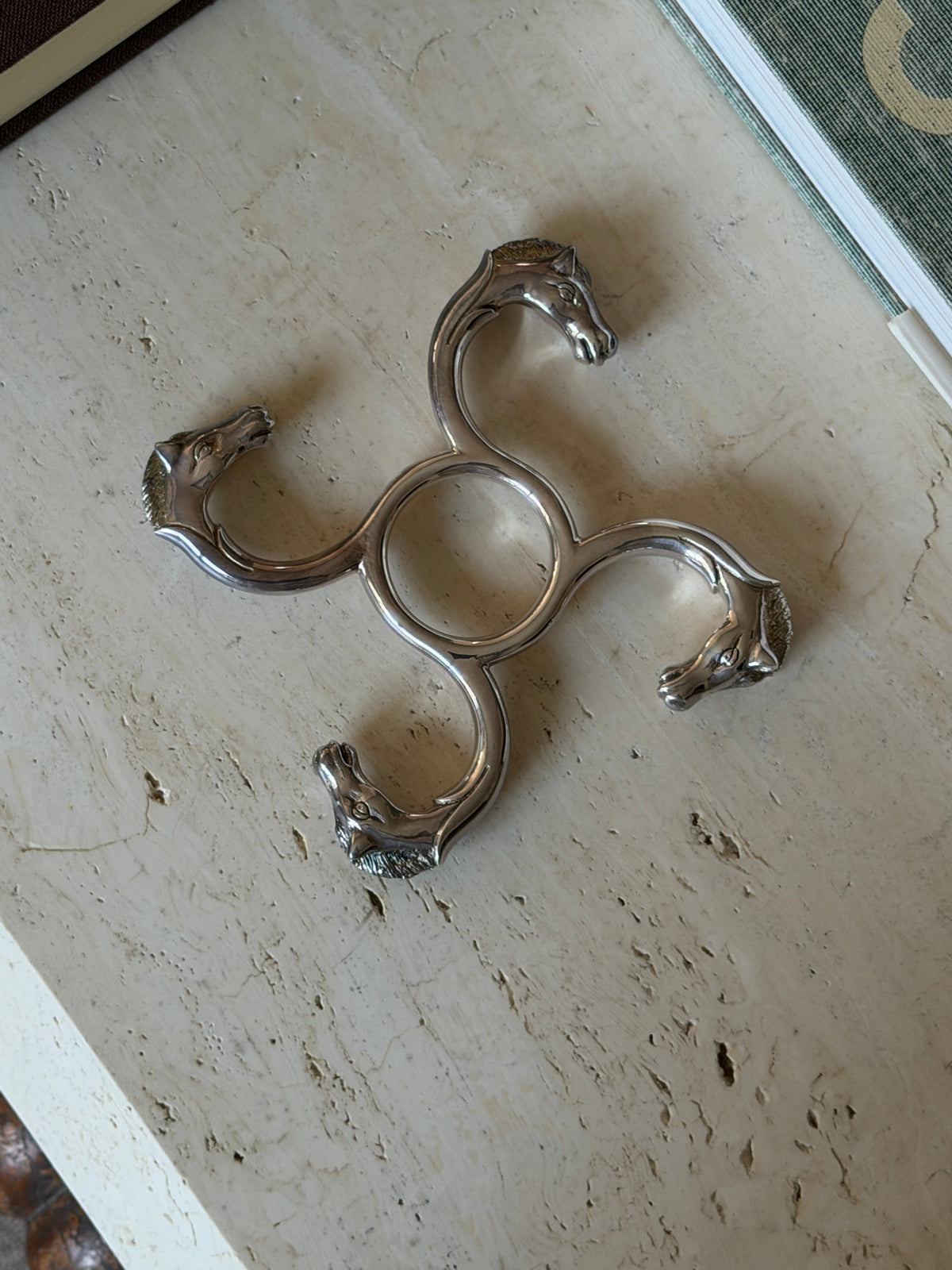 Top-down view highlighting the equestrian detailing on the Hermes silver coaster