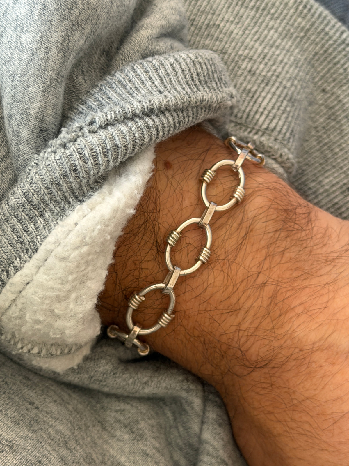 Full view of the oval and ribbed link sterling silver bracelet on wrist