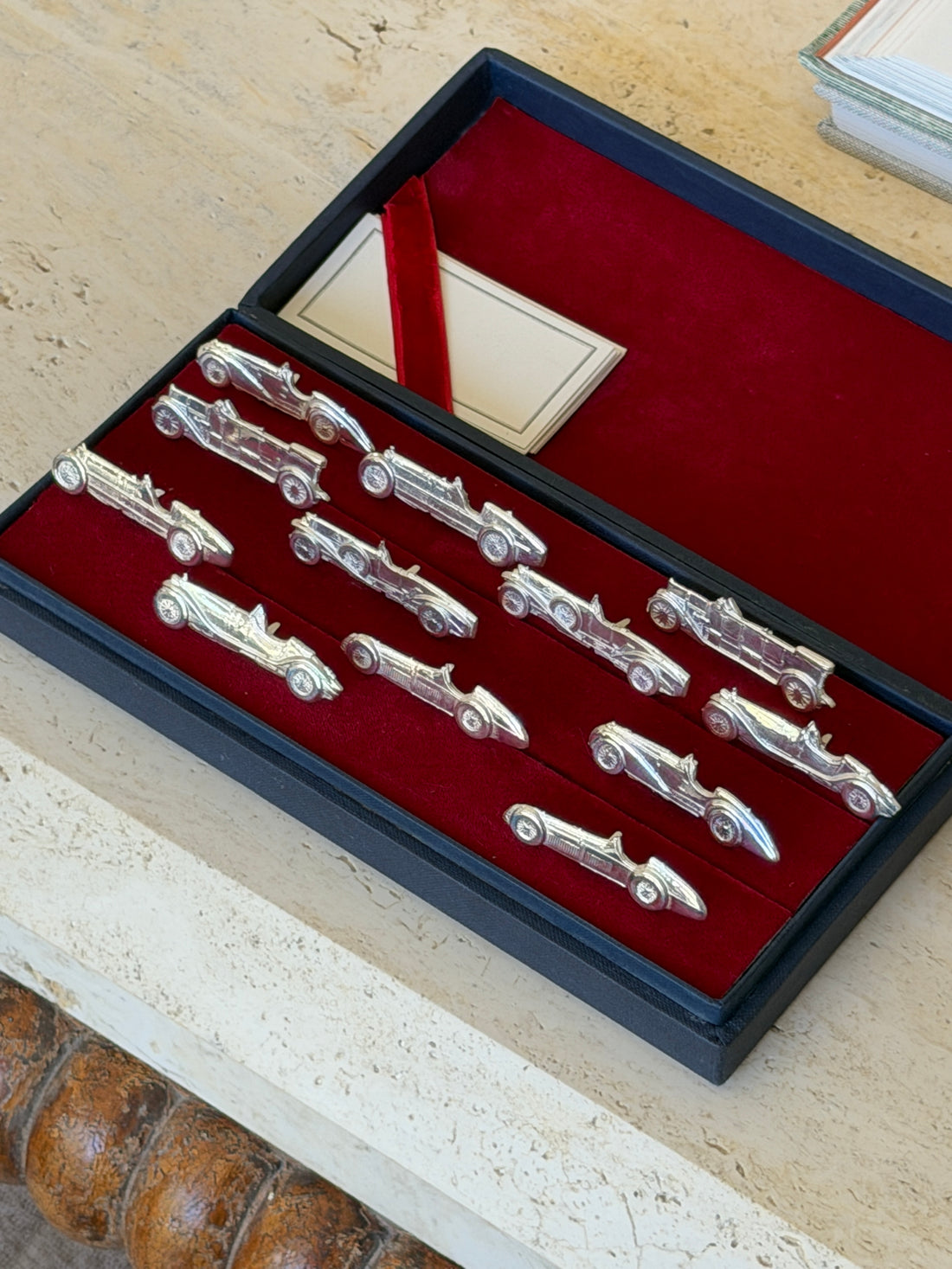 Overhead view of the full set arranged in two rows, with the ribbon-tied card visible in the corner