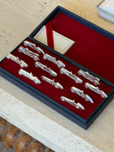 Overhead view of the full set arranged in two rows, with the ribbon-tied card visible in the corner
