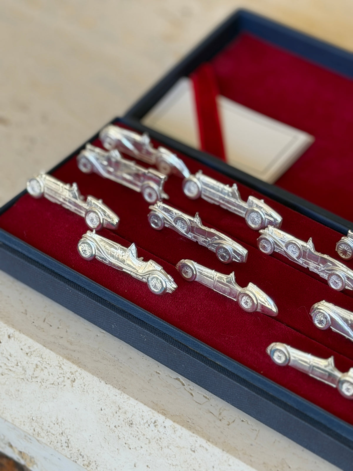 Angled view of the set from the opposite end, with the holders fanned across the velvet
