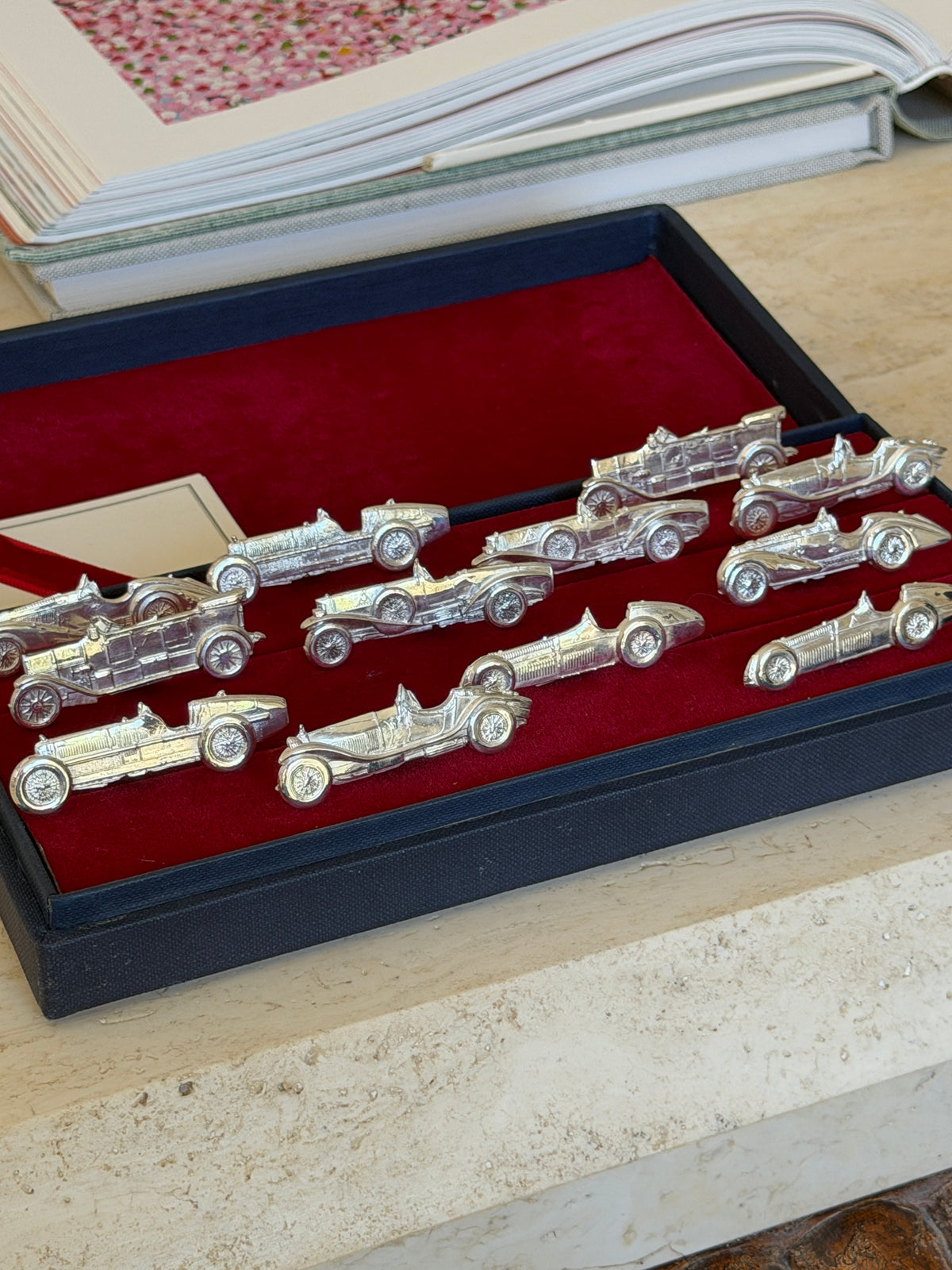 Overhead view of the full set of car-shaped place card holders arranged in the box