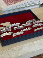 Overhead view of the full set of car-shaped place card holders arranged in the box