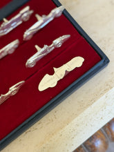 Macro close-up of one holder engraved with its Alfa Romeo model name and date