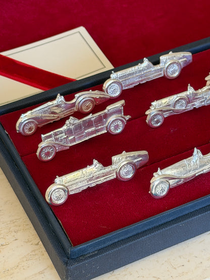 Close angled view of several cars including a flatbed-style holder among the sports car shapes