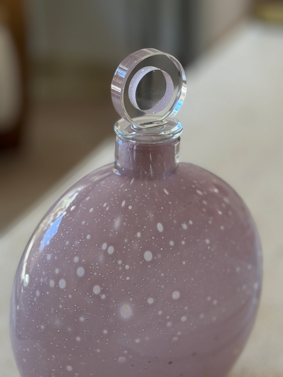 Detail of the Murano decanter neck and stopper, a clear glass disc with an inset lilac ring rising above the clear rim