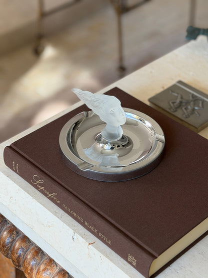 Wide angled view of the ashtray styled on a console table near a stool