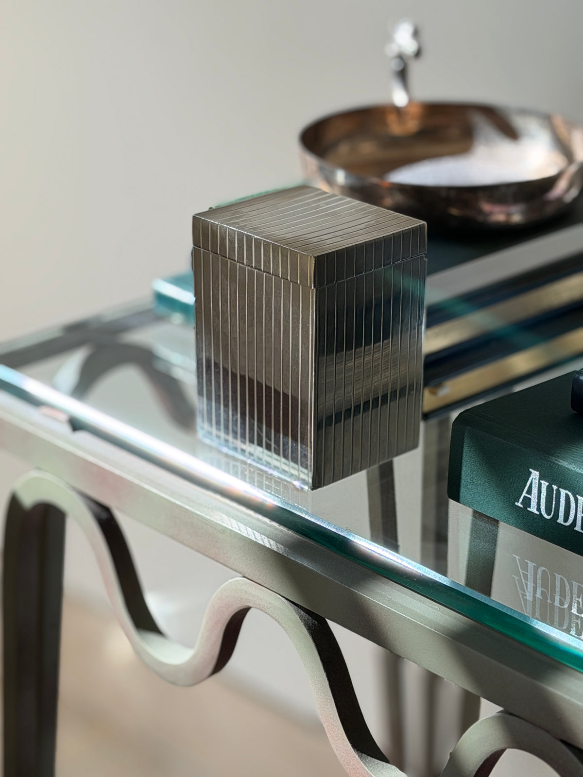 Side angle room context view of vintage silver plated Art Deco desk box styled in luxury home interior