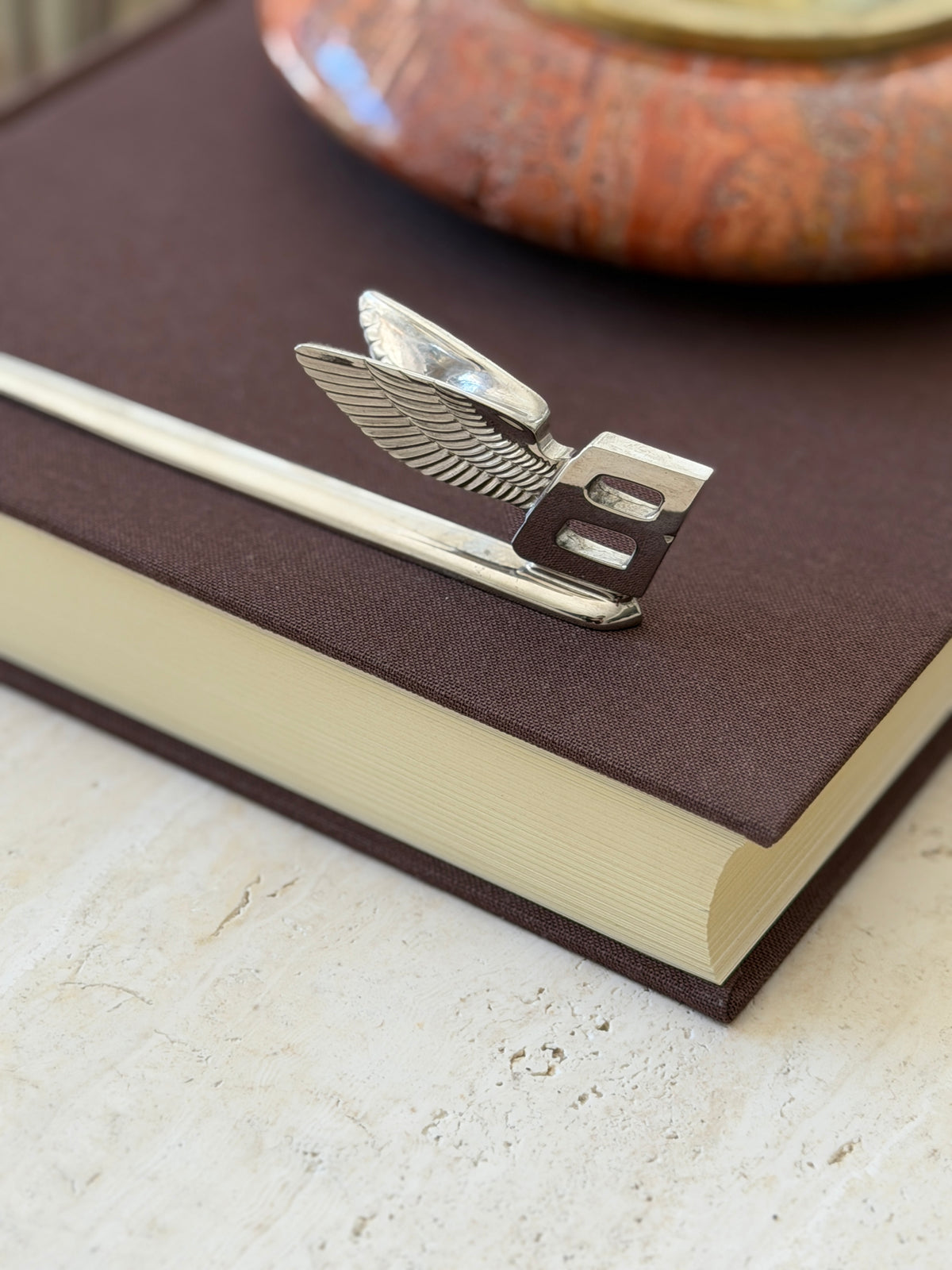 Angled detail of the Flying B emblem on the letter opener, both wings visible behind the squared B at the end of the blade