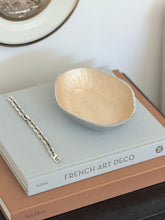 High angle perspective view of Brandani Galassia cream aluminum decorative bowl with pen available at Collectors Gene