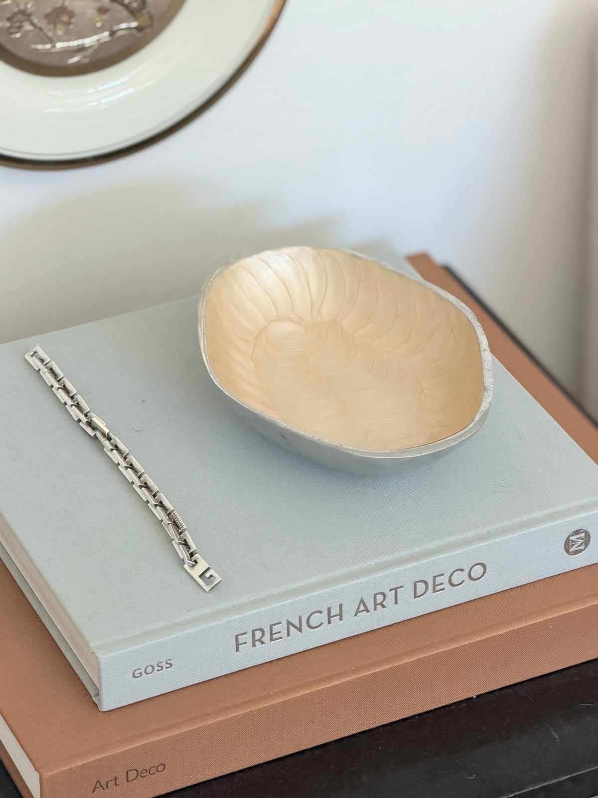 High angle perspective view of Brandani Galassia cream aluminum decorative bowl with pen available at Collectors Gene