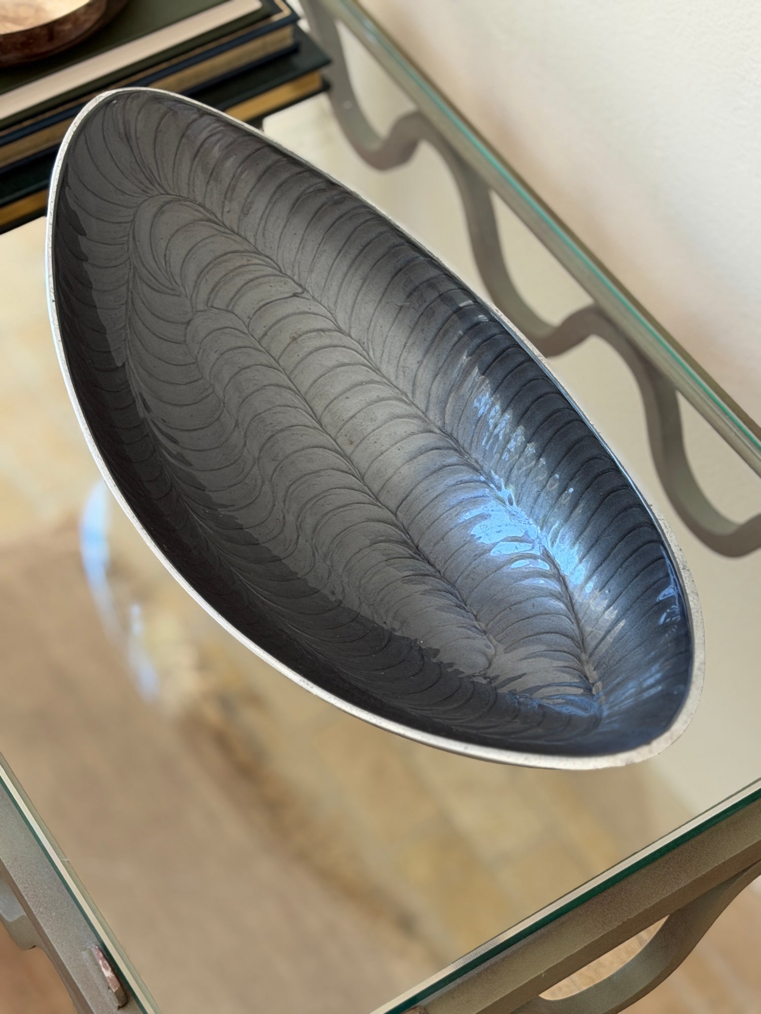 Direct top-down view showing feather-like scalloped texture inside Brandani Galassia aluminum bowl at Collectors Gene