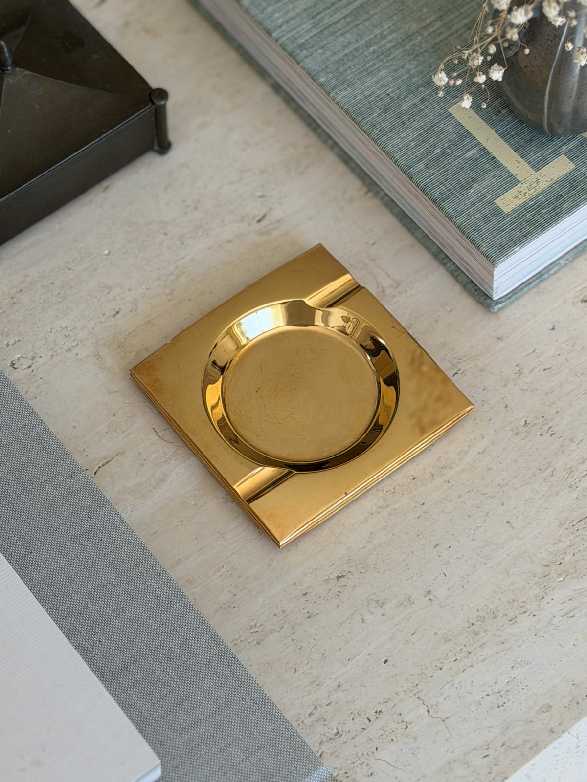High angle view of 4-inch square golden brass catchall vide poche tray available at Collectors Gene