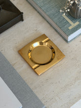 High angle view of 4-inch square golden brass catchall vide poche tray available at Collectors Gene