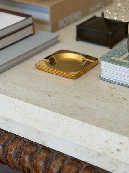 Vintage c.1960 brass square ashtray in the style of Francois de Gross styled on travertine table from Collectors Gene