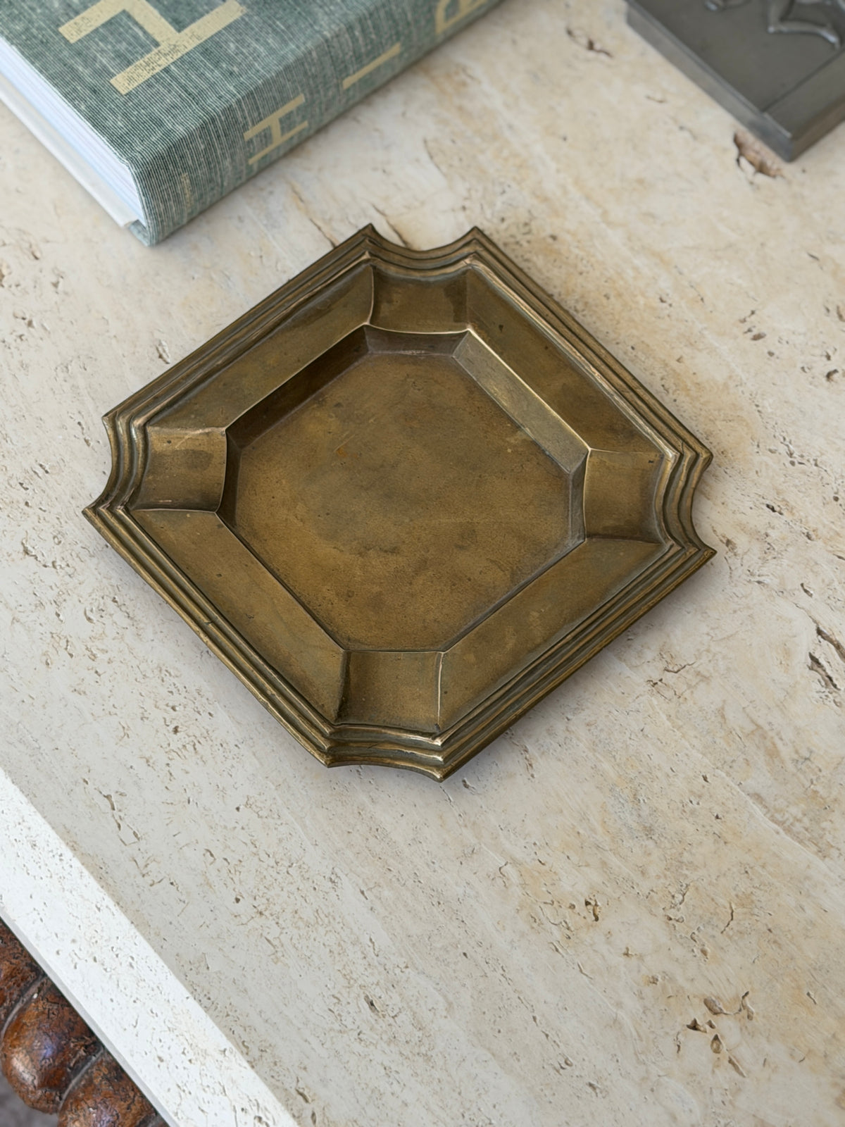 Vintage mid-century brass geometric ashtray vide poche from Collectors Gene on travertine table surface