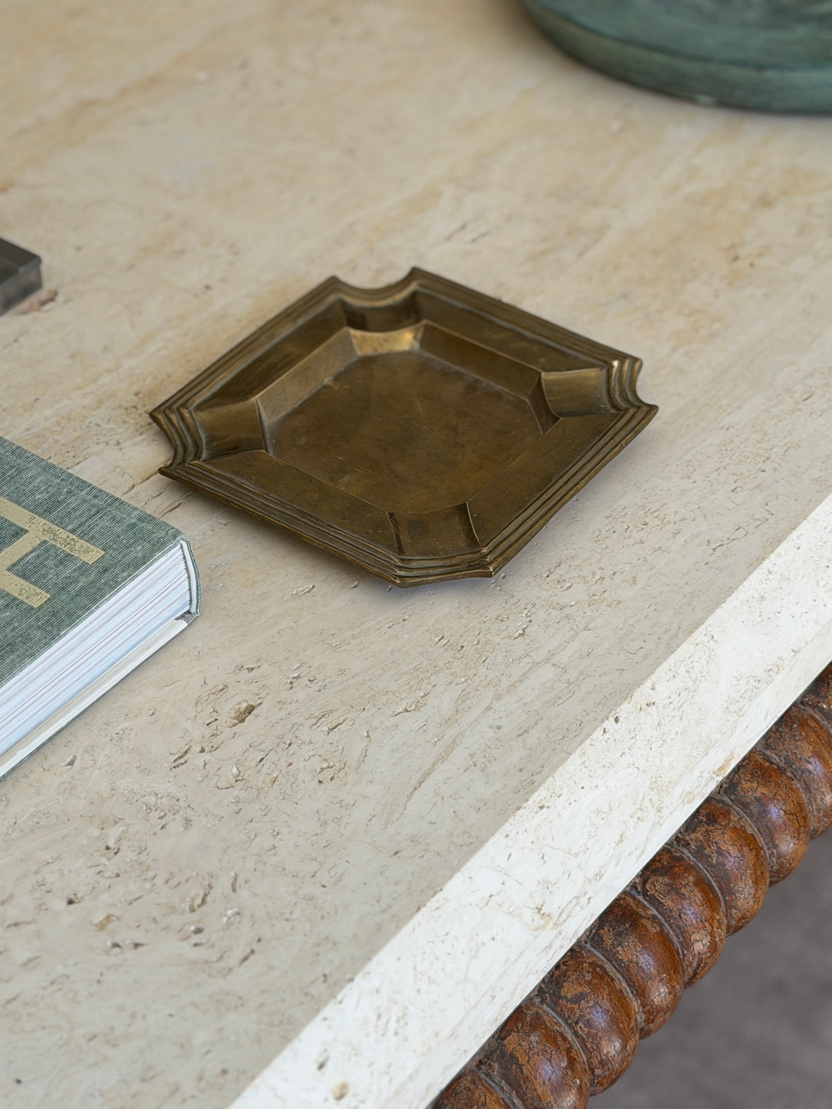 Vintage mid-century patinated brass geometric vide poche catchall dish displayed on executive desk