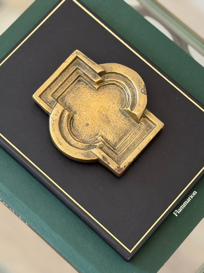 Close-up top-down view of aged bronze architectural geometric tray showing muted gold patina details