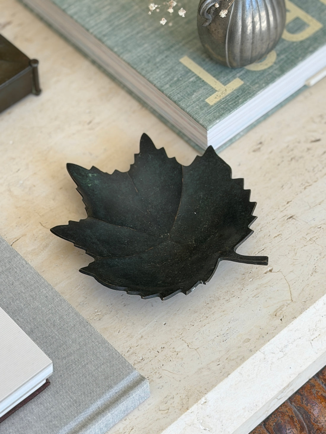 Collectors Gene vintage dark patinated bronze leaf figural vide poche catchall dish on travertine surface