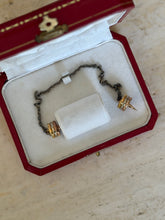 Overhead view inside the box showing the chain coiled around its fabric wrap with both spiked ends visible