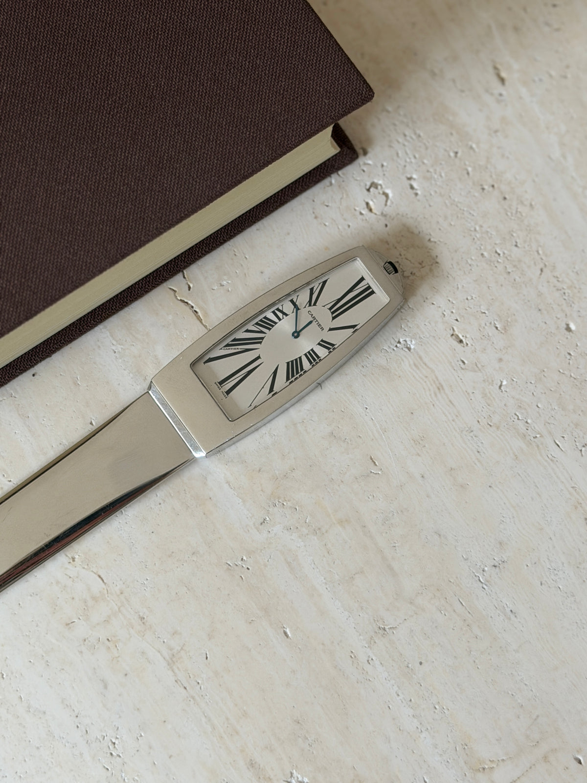 Closer view of the clock face set into the handle, showing the Roman numeral dial and Cartier signature