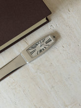 Closer view of the clock face set into the handle, showing the Roman numeral dial and Cartier signature