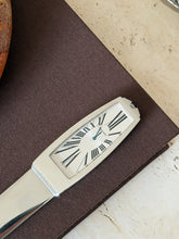 Another close-up of the clock face from the front, showing the hour and minute hands and Roman numerals