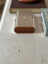 Angled view of the Cartier lacquered wood box styled on a desk