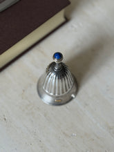 Close-up from above of the fluted handle and lapis cabochon finial, showing the beaded detail around the stone
