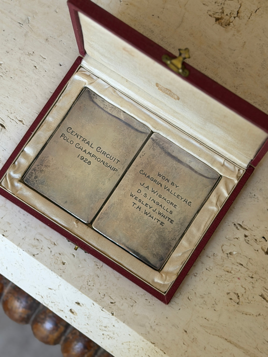 Overhead view of the engraved silver panels inside the Cartier case reading Central Circuit Polo Championship 1928