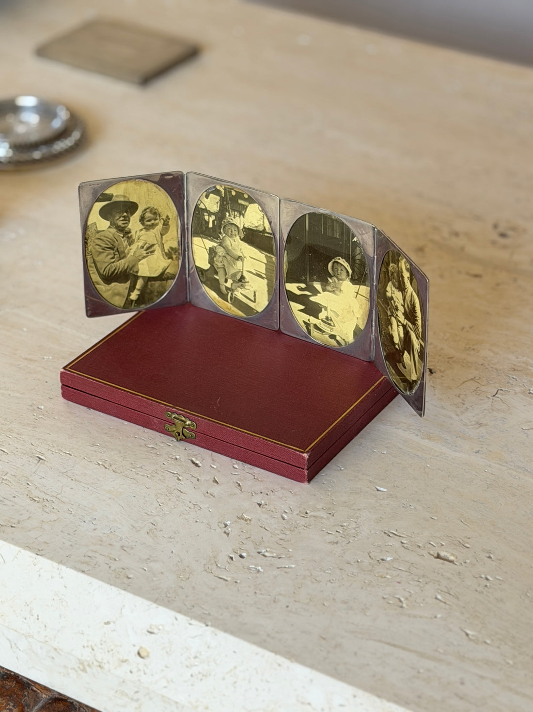 Cartier four photo frame unfolded and standing upright with its oval vintage photographs