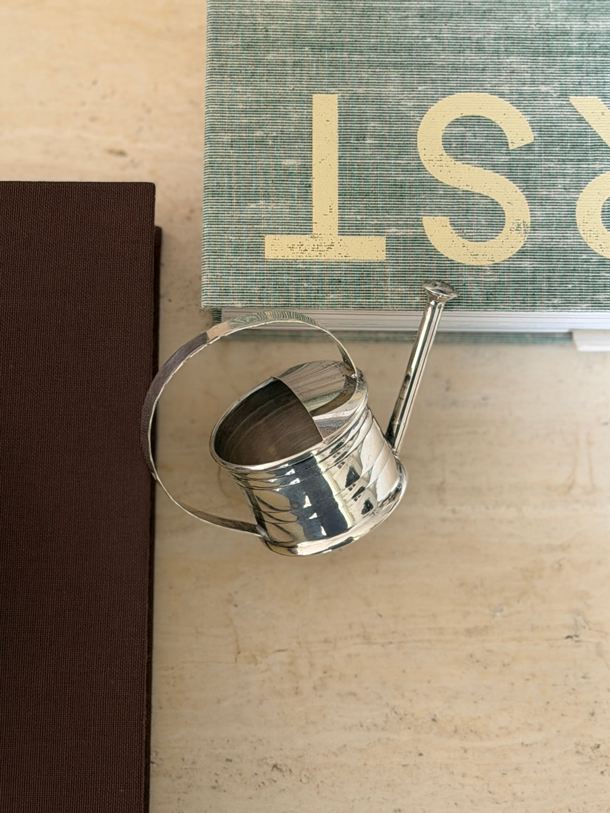 Top-down view of the Cartier vermouth dropper resting on a stack of books
