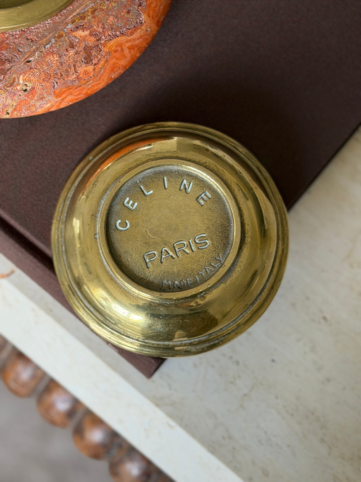 The dish turned over, showing Celine Paris stamped into the brass base