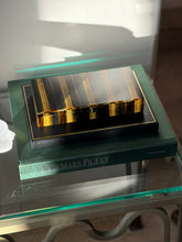 Angled view of the closed Chaumet box displayed among books and decorative objects