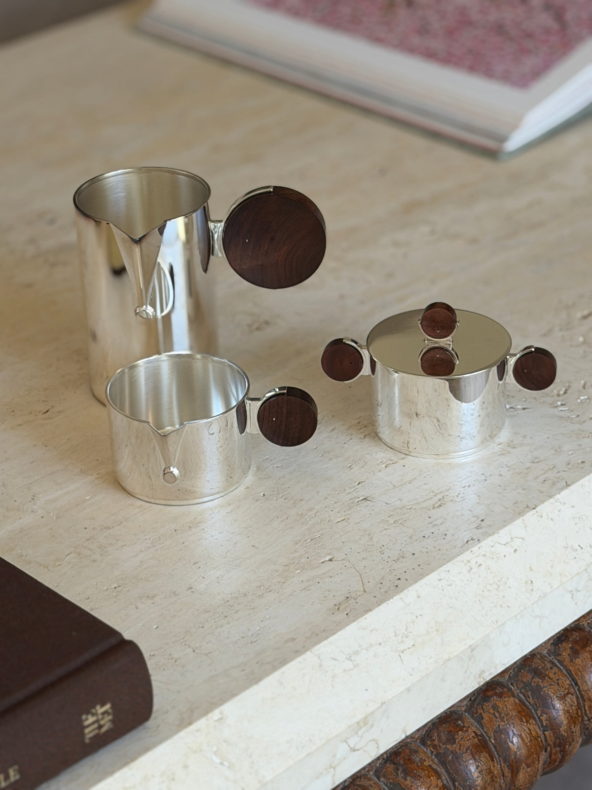 Another angle of the separated Gigogne coffee service pieces on a stone surface, showing the sugar bowl&