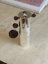 Nested Gigogne coffee service stack against a blurred pink art print in the background