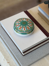 Angled perspective of Christofle green ginkgo porcelain decorative box styled on books at Collectors Gene