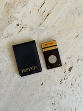 Side profile view of the Ferrari cigar cutter and leather pouch together