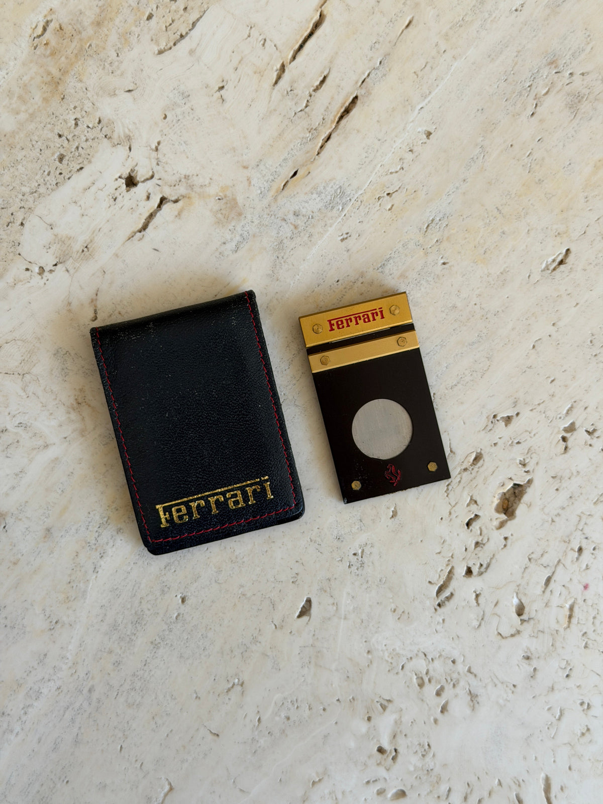 Side profile view of the Ferrari cigar cutter and leather pouch together