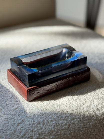 Side profile view showing thick sommerso glass walls and leather-covered base of Seguso Murano glass catchall dish