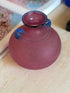 Top-down view into the pink amphora vase showing the glossy interior of the neck and the applied thread wrapping the shoulder