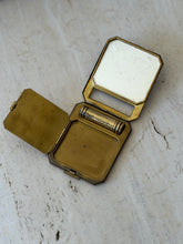 Compact fully opened with the inner powder lid folded back, showing the brass well, the mirror, and the stamped CORONA PARIS and MADE IN FRANCE marks