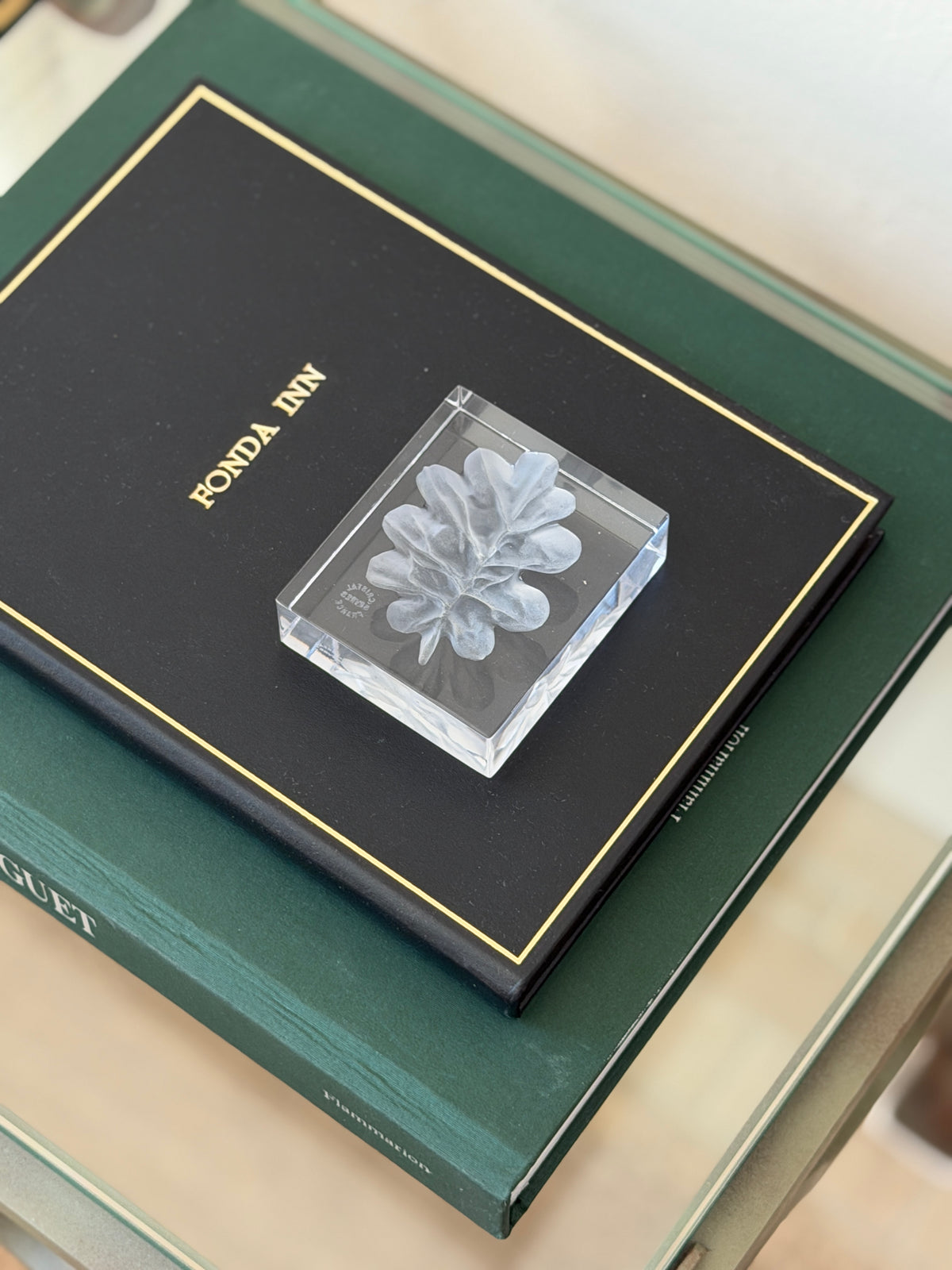 Collectors Gene vintage French sculpted crystal paperweight with frosted botanical leaf motif on green book