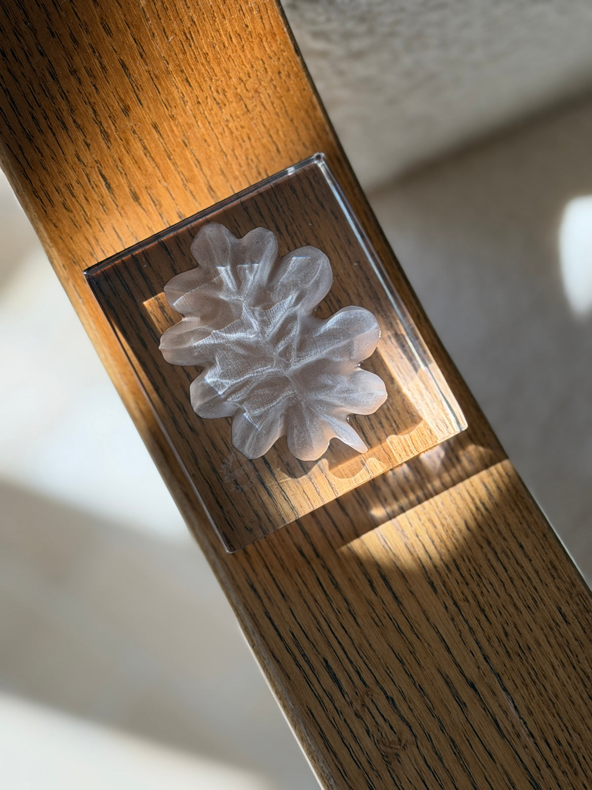 Close-up view highlighting internal frosted glass leaf design in heavy rectangular crystal paperweight