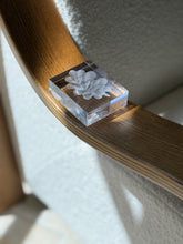 Angled perspective view of heavy French clear crystal desk paperweight showing frosted botanical leaf carving