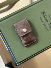 Gucci monogram leather case for the folding travel shoehorn, shown closed